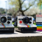 real polaroid camera sits next to a lego version