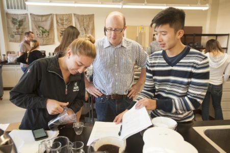 Associate professor William Ristenpart talks with UC Davis students Sabrina Perell and Kyle Phan about the taste of their brew during a “Design of Coffee” class in 2015