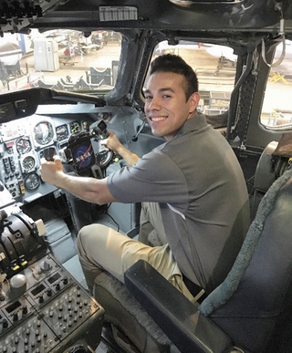 Felipe Valdez sitting inside the cockpit of a NASA aircraft.