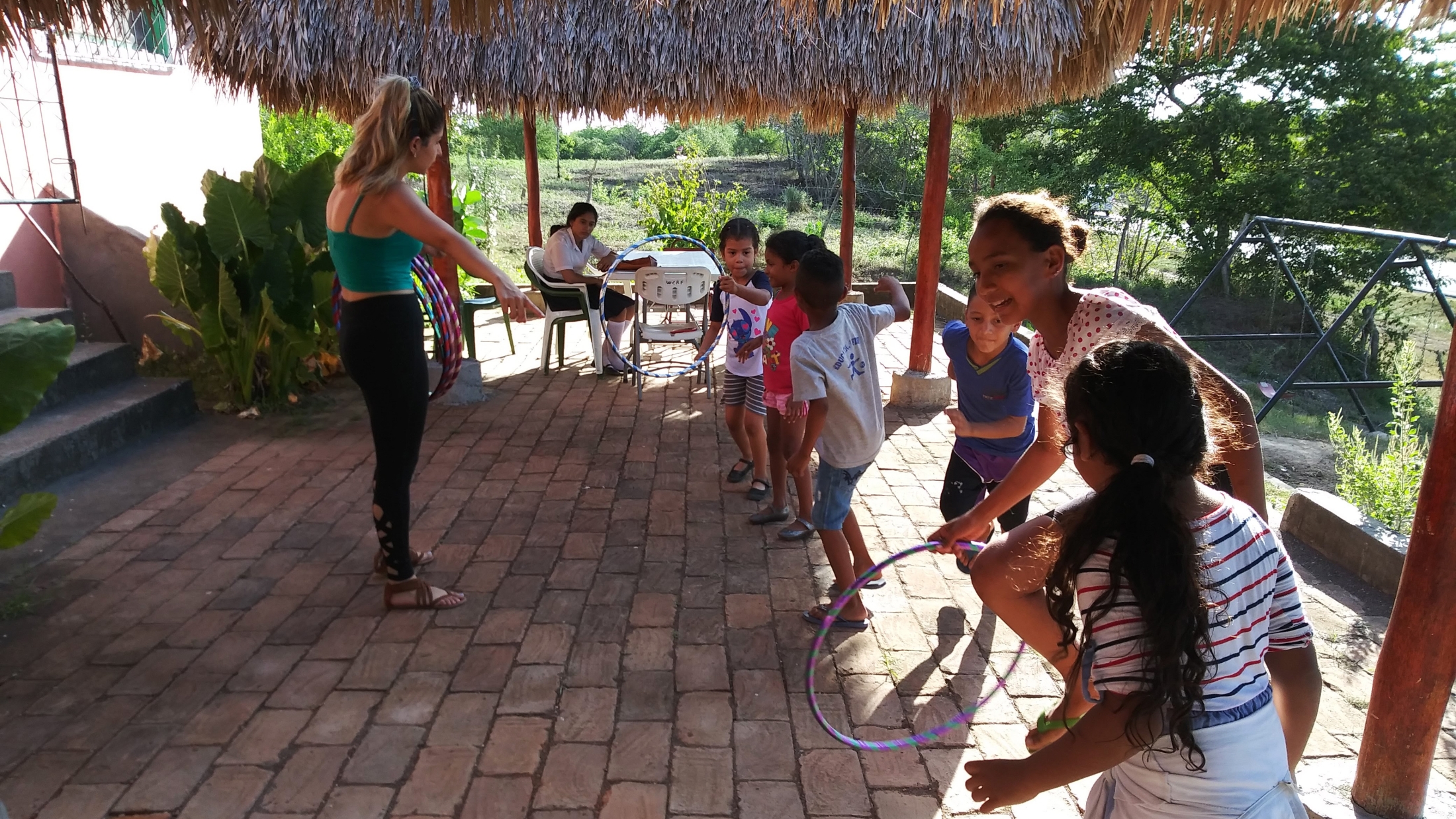 Explaining relay races with hula hoops at the end of the Reading Palooza, before the caponera (motorcycle with bench) came to take the kids home.
