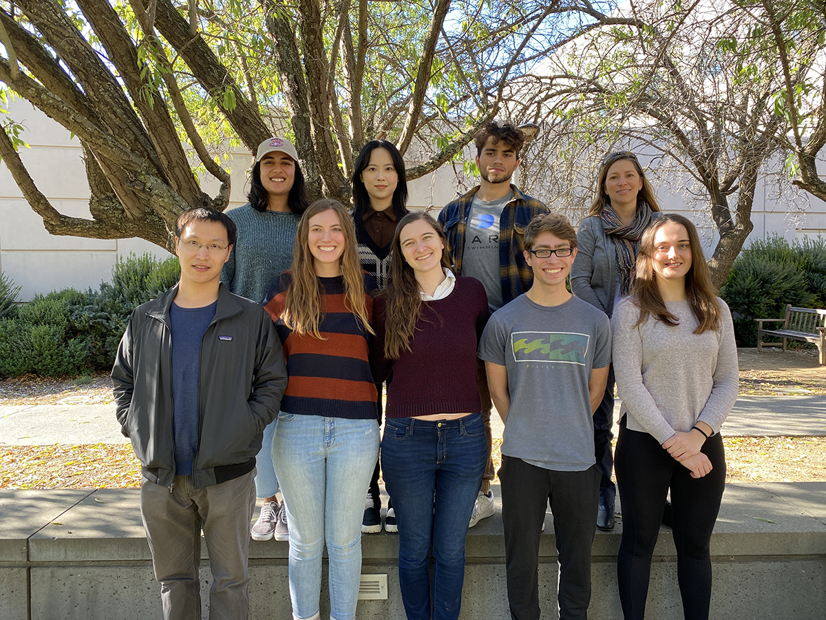 Group photo of 9 individuals outside on the UC Davis campus near a tree