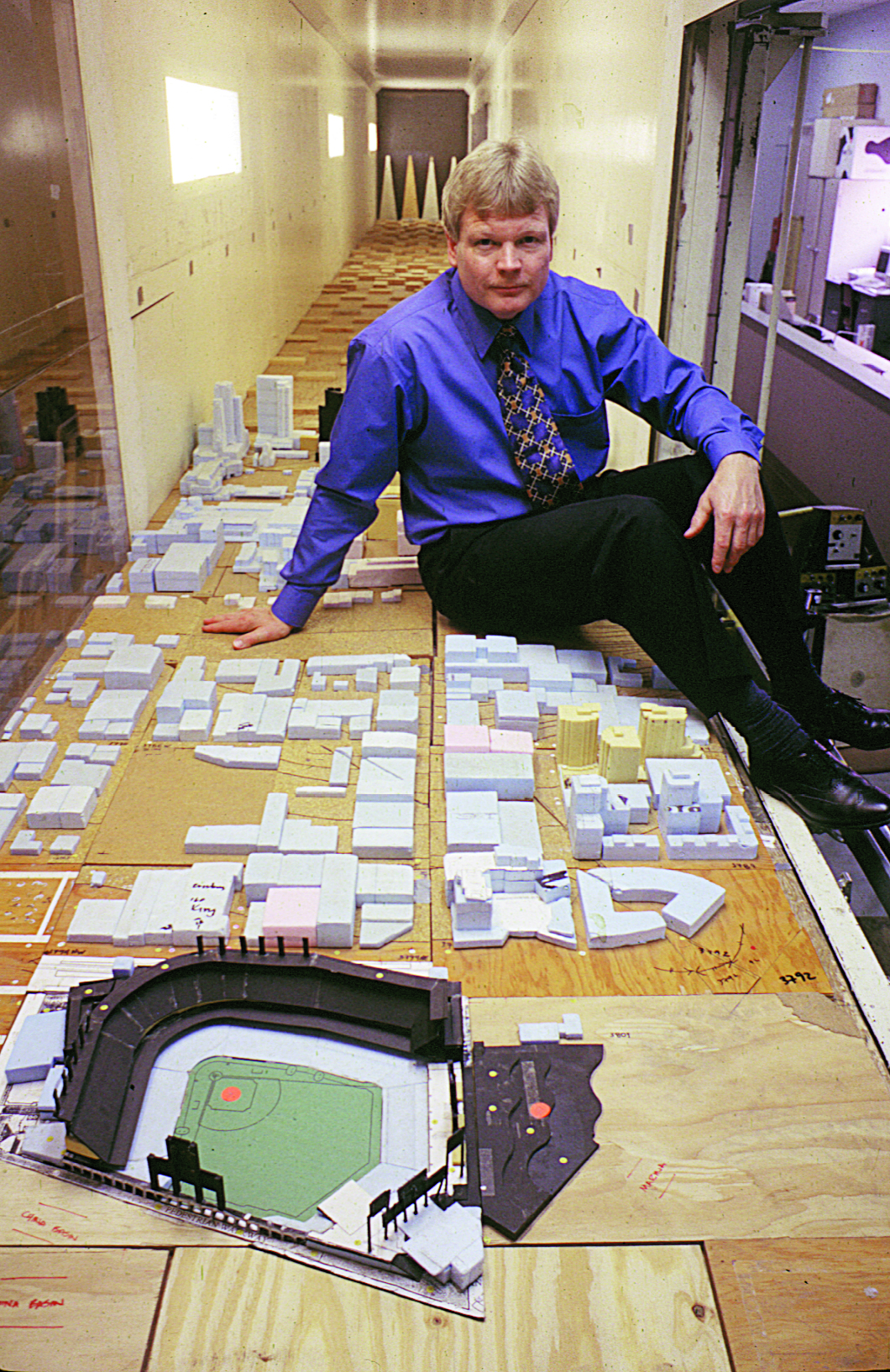 Professor Bruce White sits inside the Atmospheric Boundary Layer Wind Tunnel with 3D models of San Francisco and the then-new Pac Bell Park