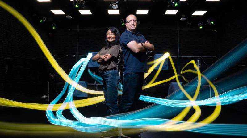 Flight paths indicated by light trails encircle lab manager Yuka Minton and professor Michael Yartsev