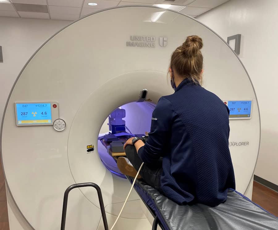 Ekaterina sits on PET scanner