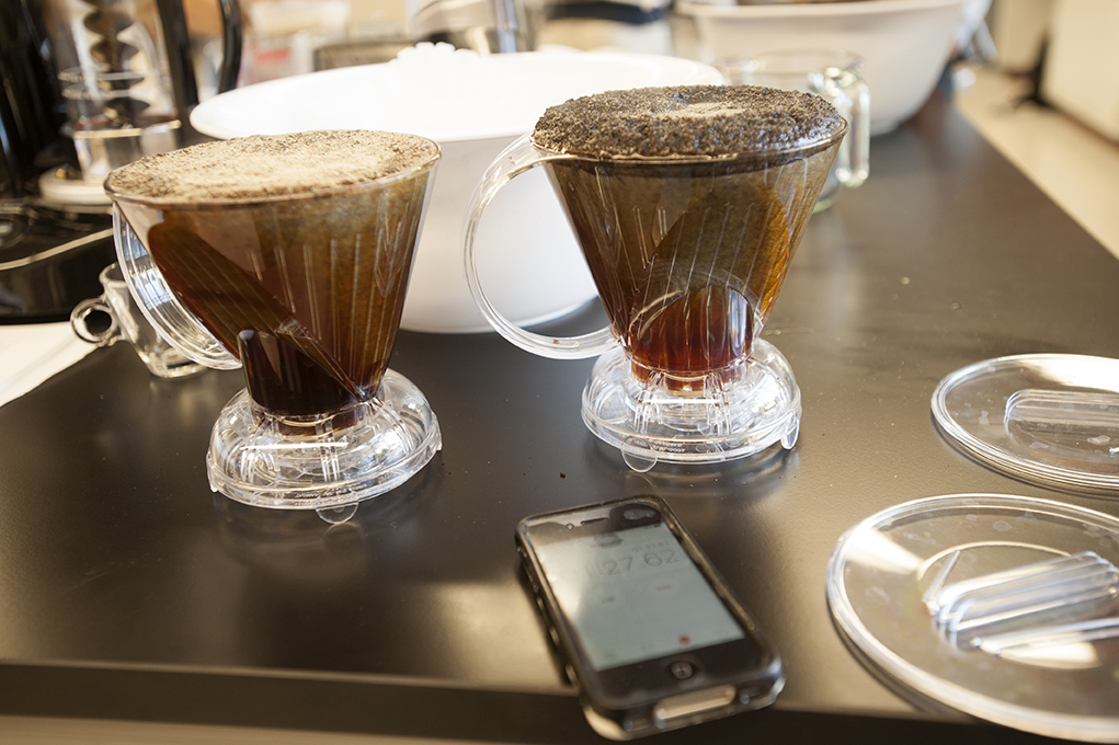 Two coffees steep in pour over containers
