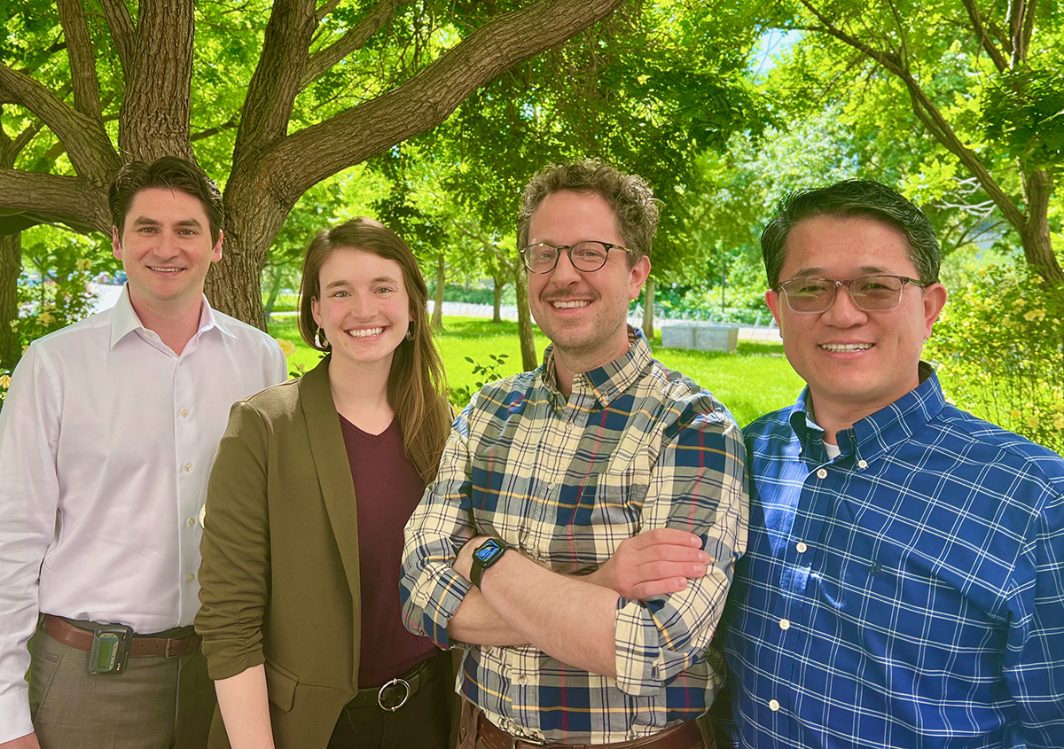 Four people stand outdoors