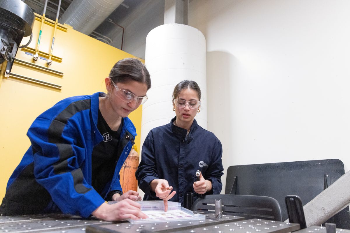 Miteza and Araya wearing safety goggles work together in the UC Davis ESDC