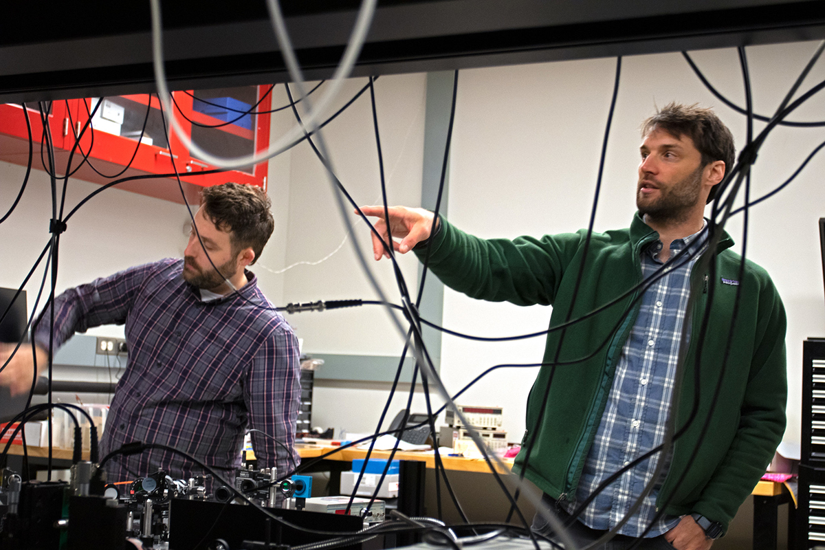 Glick and Putnam work in the lab where many wires are seen