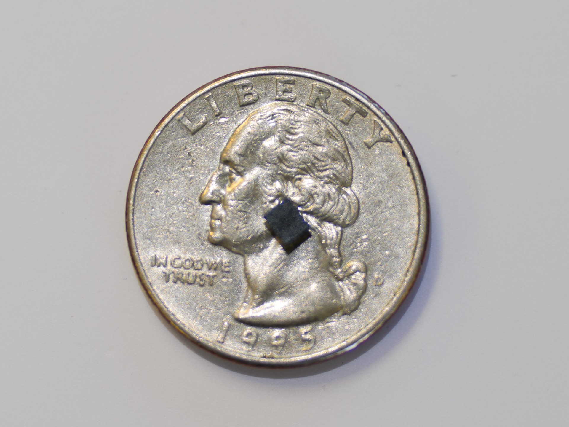 Quarter with a small rectangular sensor sitting on top
