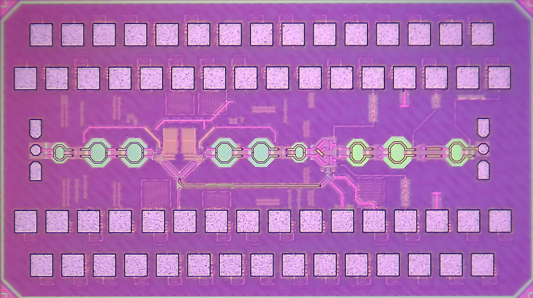 A circuit board with rows of squares against a mauve background. 