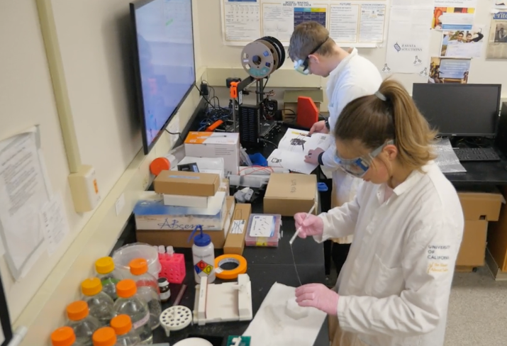 Noelle and Vanderpan in a lab