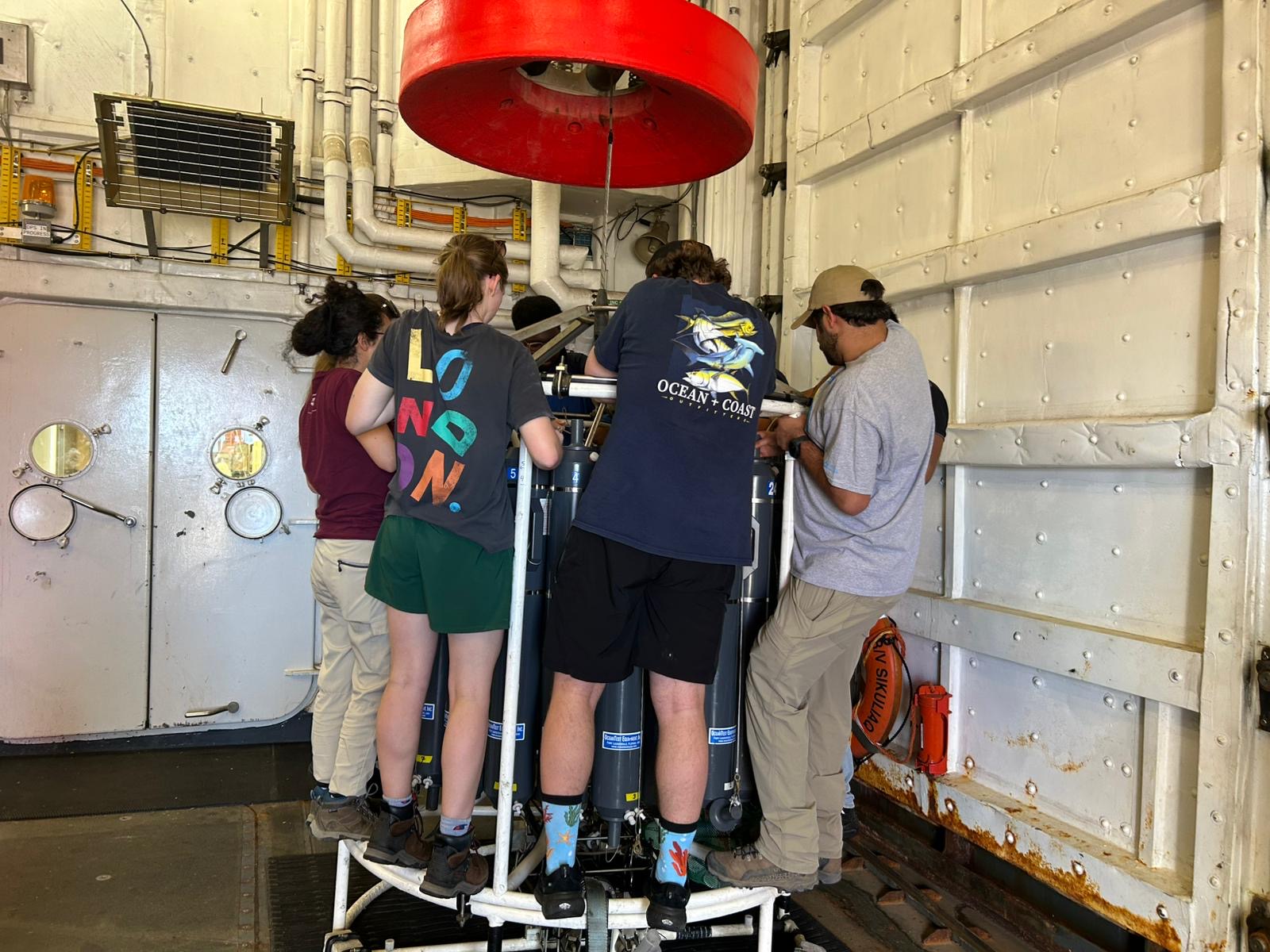 A group of people gathered around a conductivity device