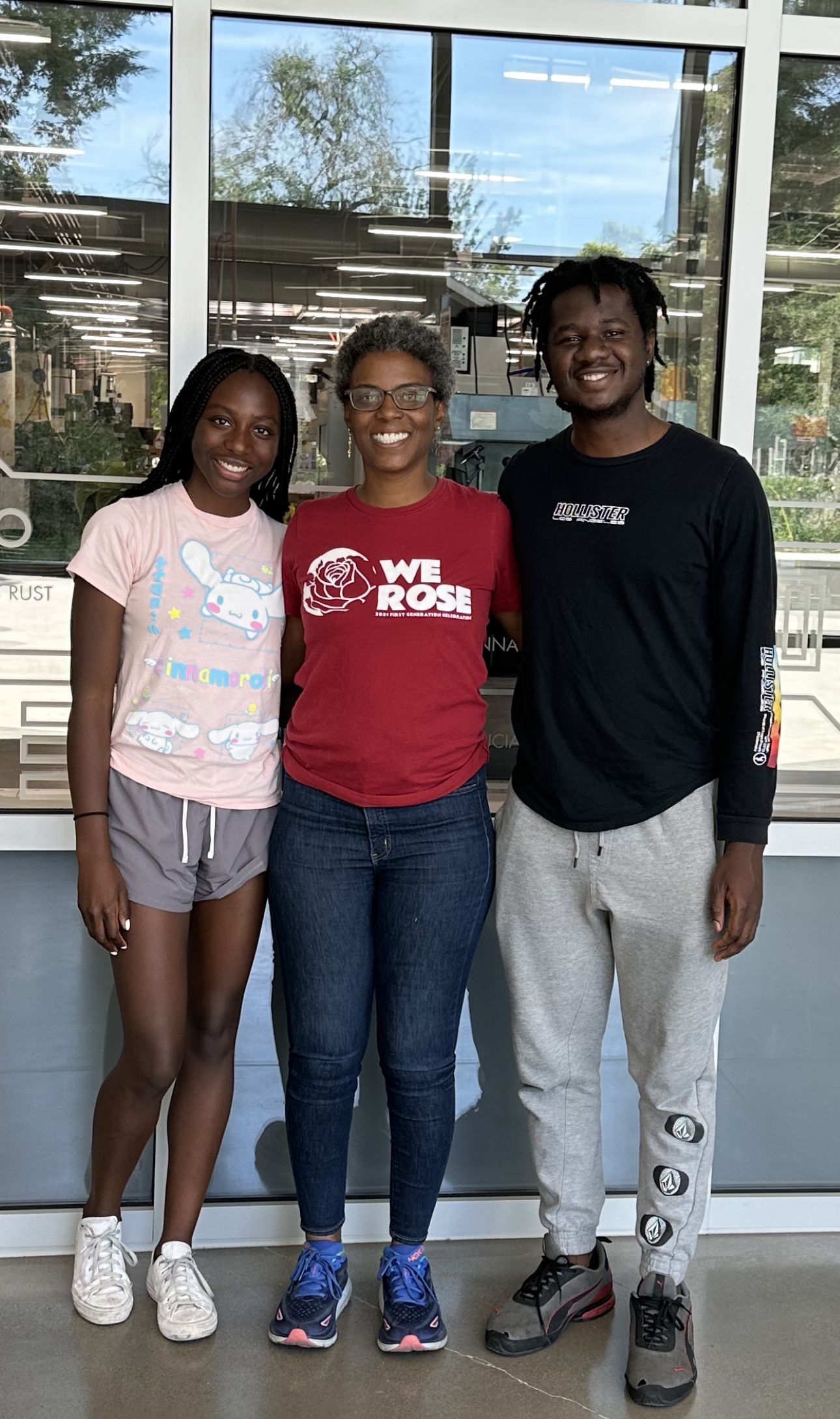 Dawn McGee, center, stands between Shelby Dioum, left, and Elijah Yeboah, right, in the lobby of the Diane Bryant Engineering Student Design Center.