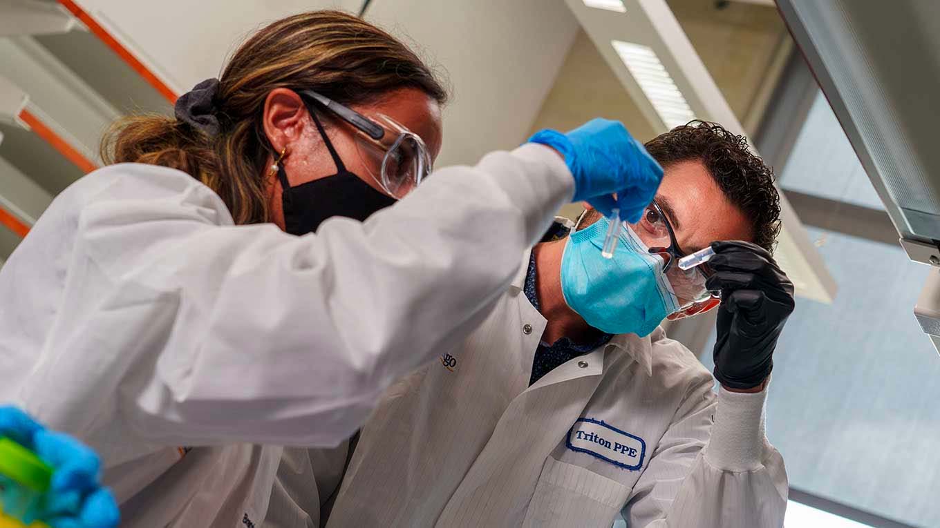 Researchers examining vials in lab