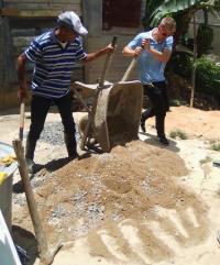 Buggy (right) helps prepare materials during his project in Constanza, Dominican Republic. Courtesy of Tiven Buggy.