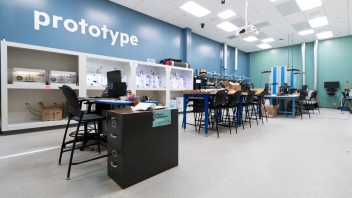 A workshop with desks and the word "prototype" painted on the back wall
