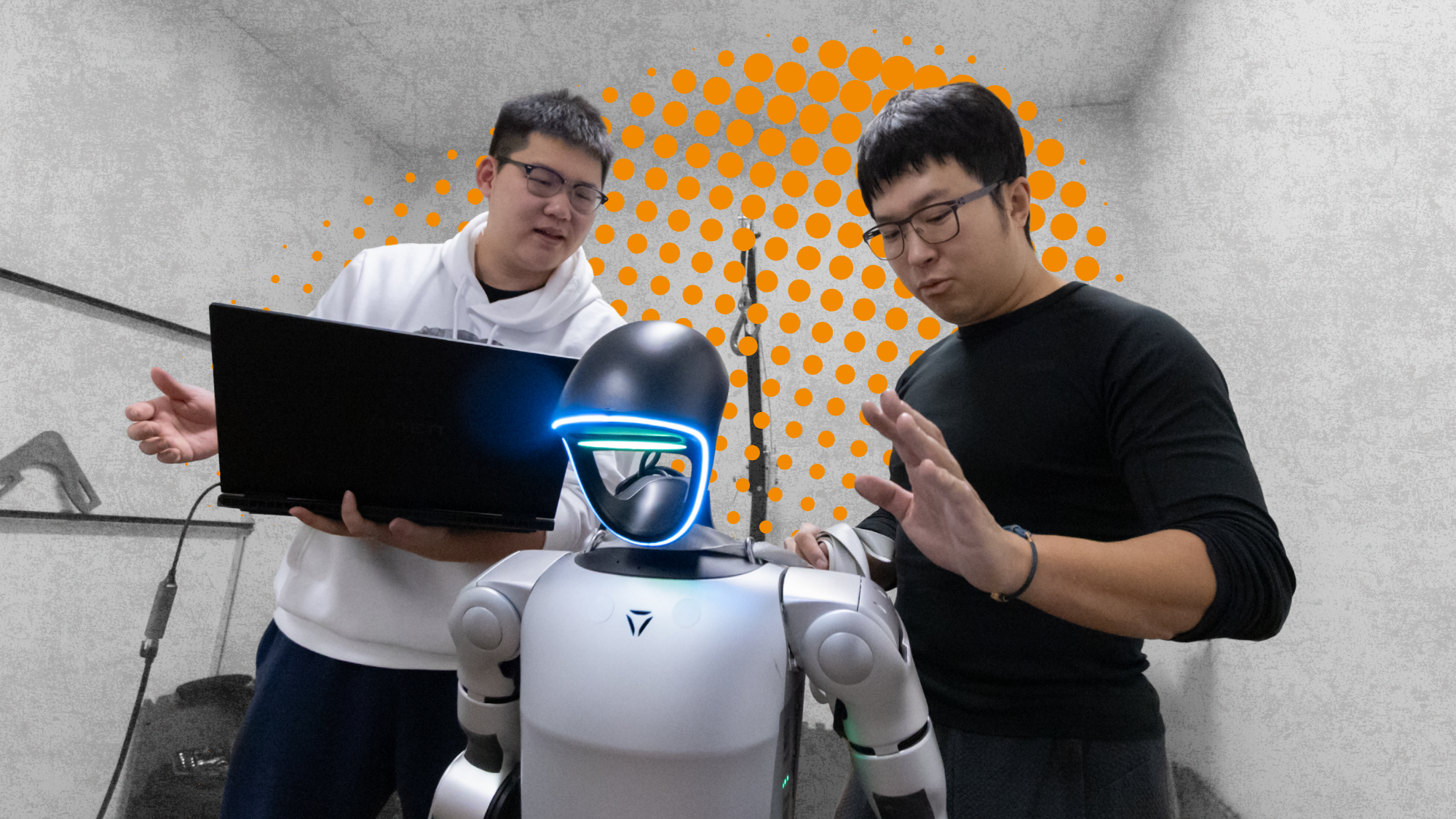 Two people stand with a robot at UC Davis