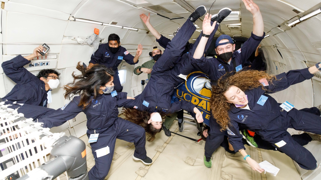 MAE students floating in a spaceship
