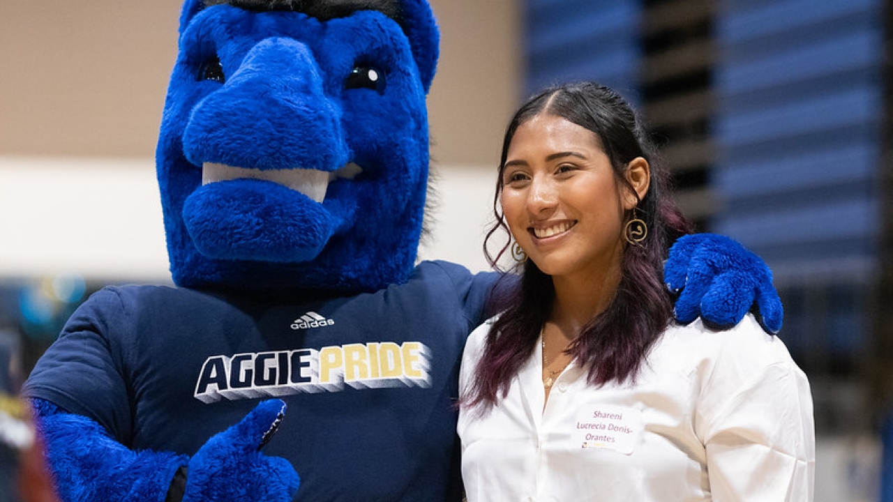 UC Davis mascot poses with a recent alum