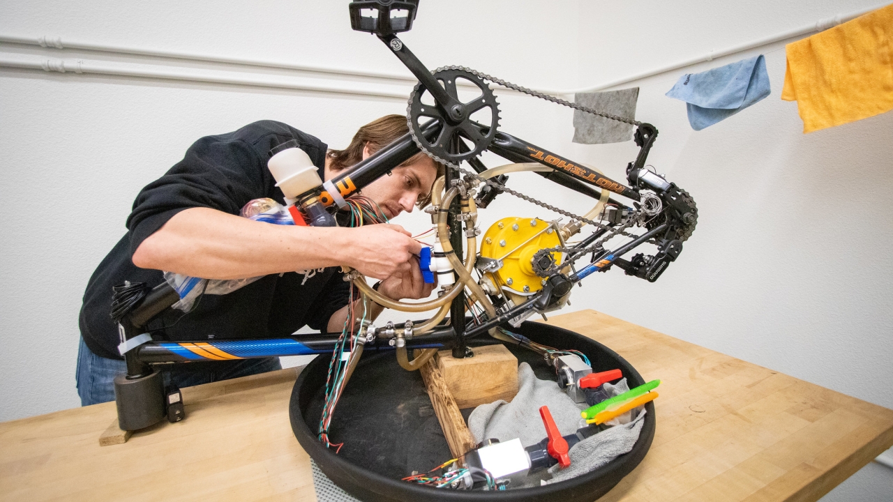 Student works on a machine made from bicycle parts