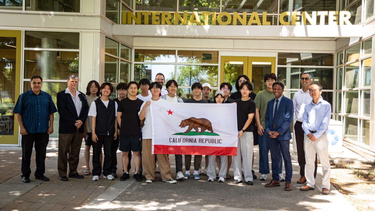 Students from Korea University hold up the flag of California