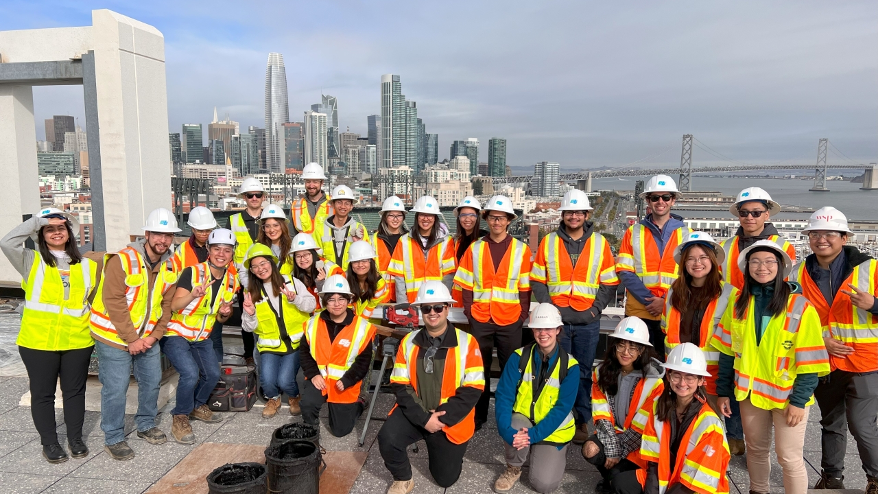 UC Davis civil engineers pose for a group photo, all wearing safety vests and hard hats