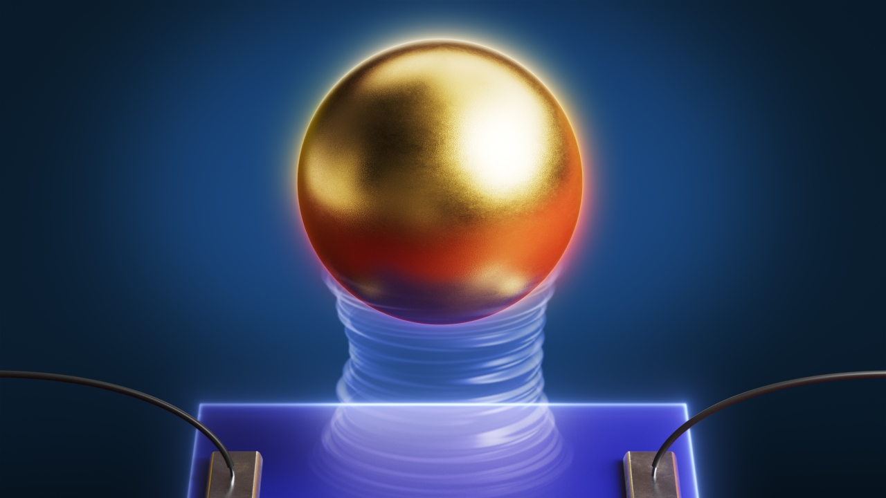 A gold sphere levitates over a semiconductor on a blue background