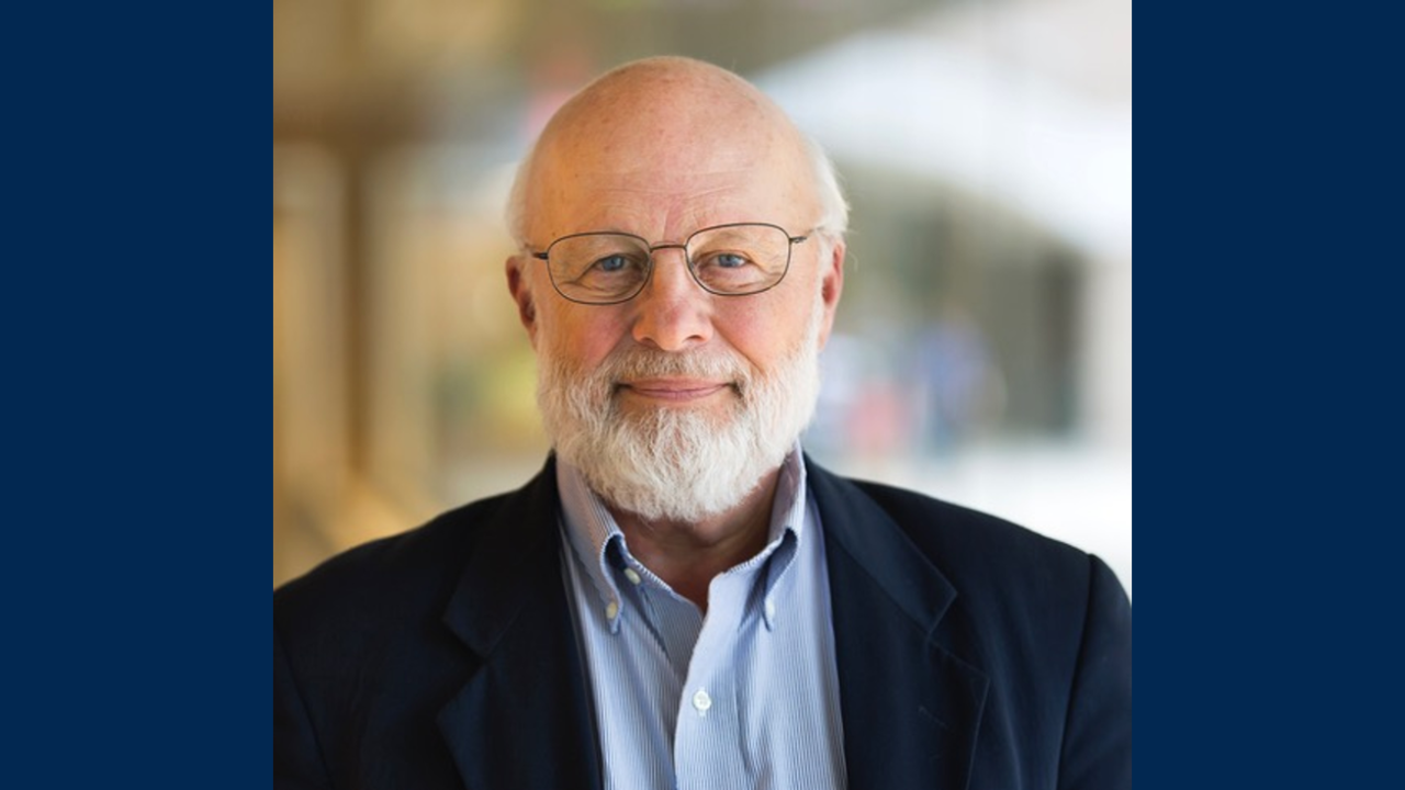 Daniel J. Inman with glasses in a navy blazer