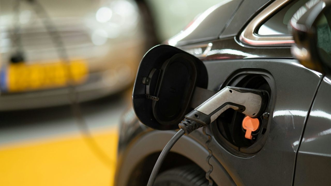 A black electric vehicle is parked as it charges