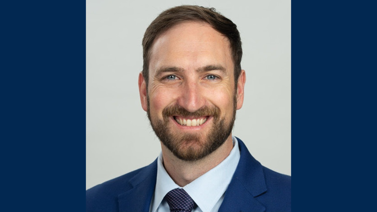 Justin Ray in blue suit and tie