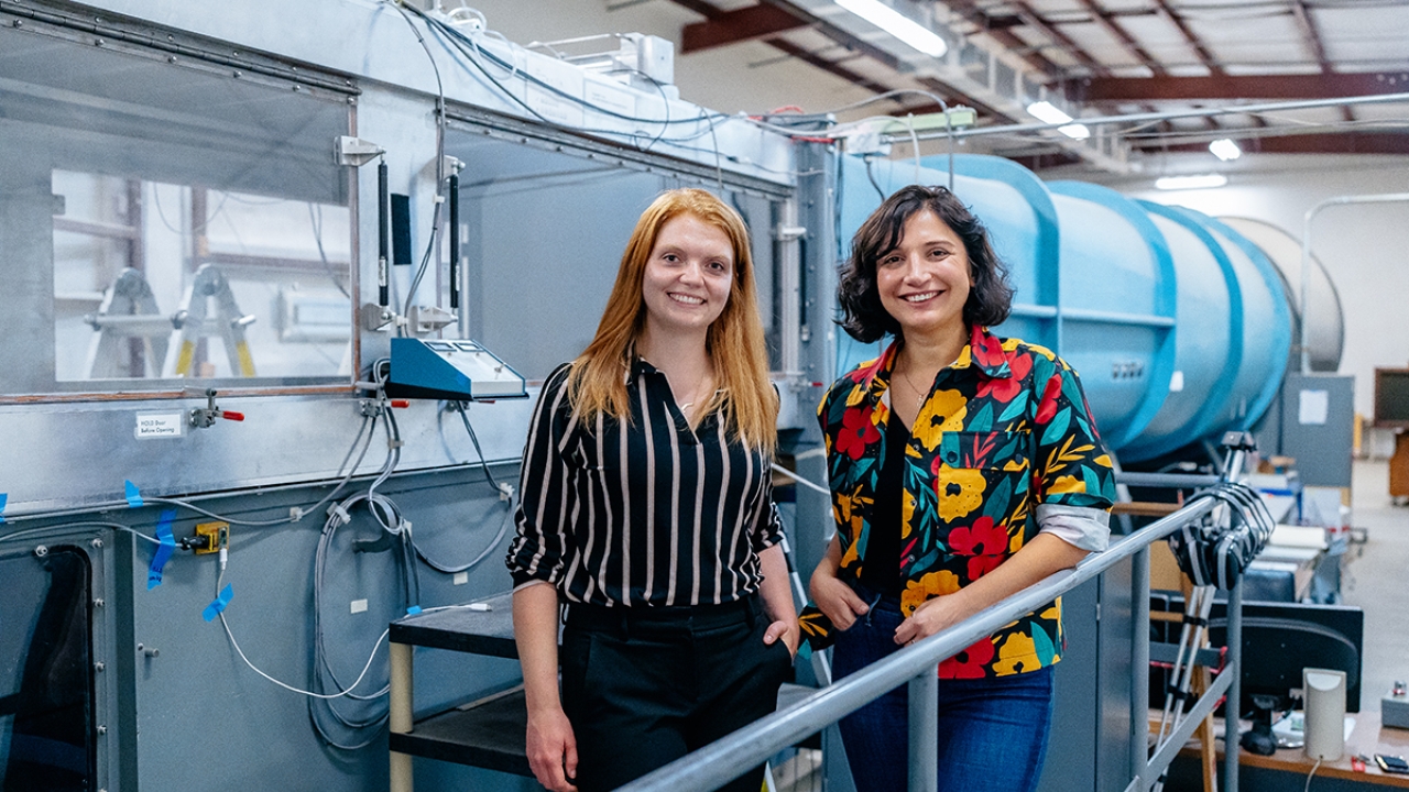 Christina Harvey and Camli Baydra in front of wind tunnel