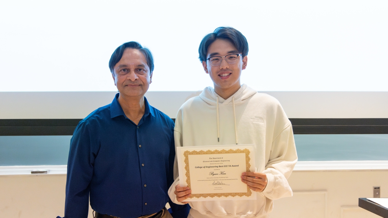 Ryan Kim holding a certificate next to Saif Islam
