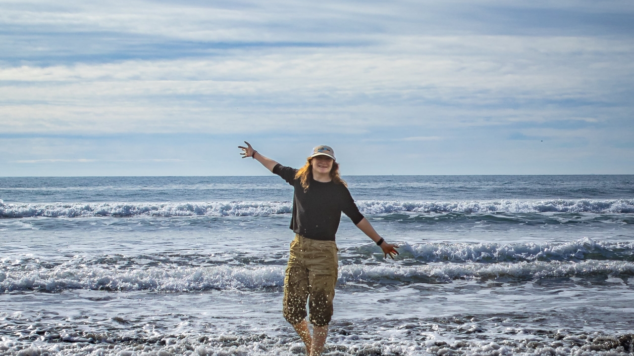 Humphries standing in shallow beach waves