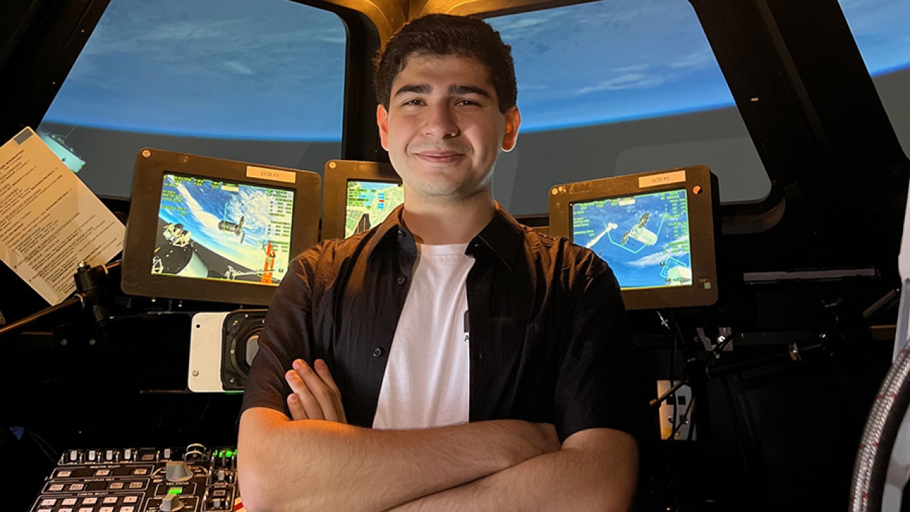 Aidan Guerra stands in the Alpha Dome