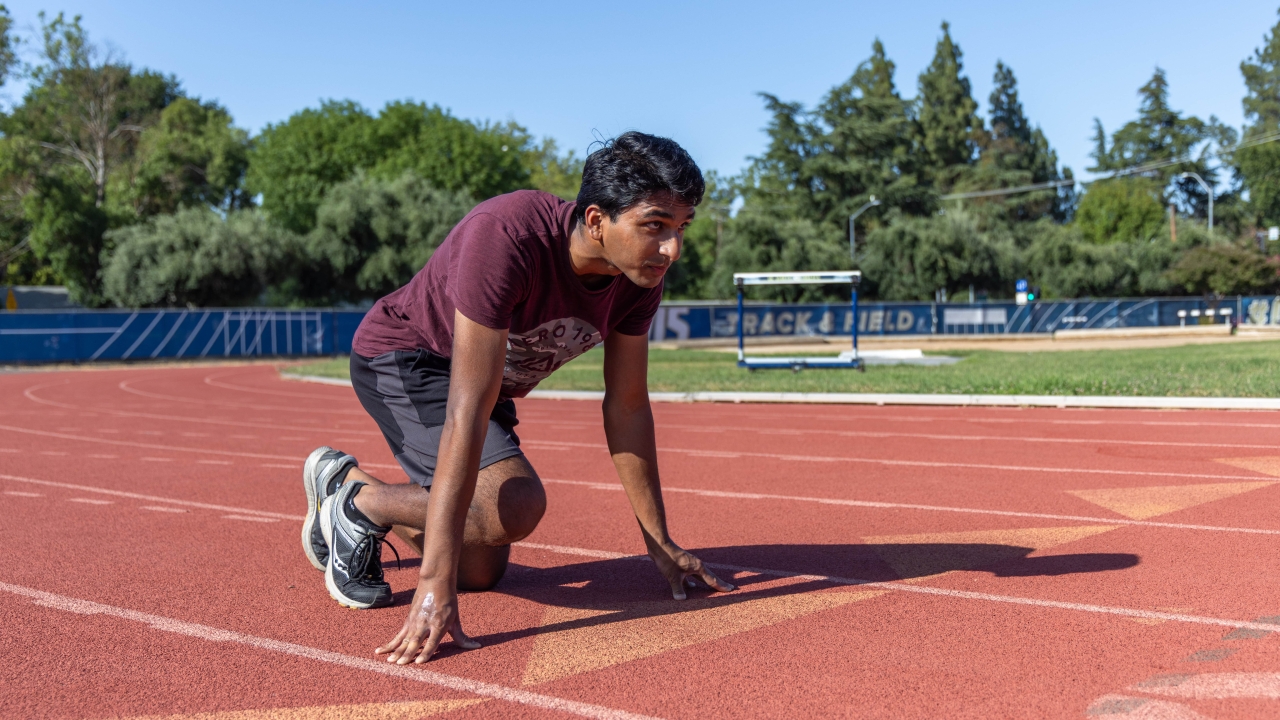 Saha crouched on a track to begin running