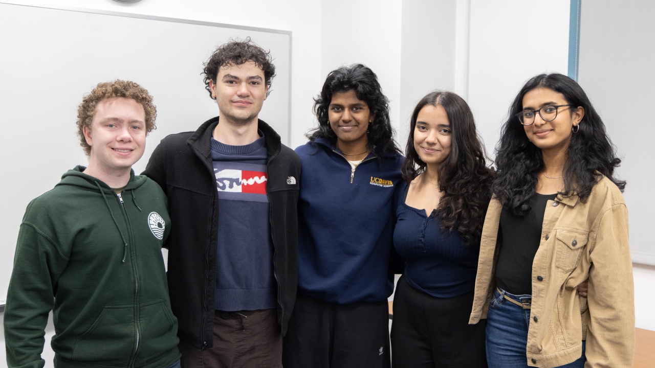 Five people posing for a photo