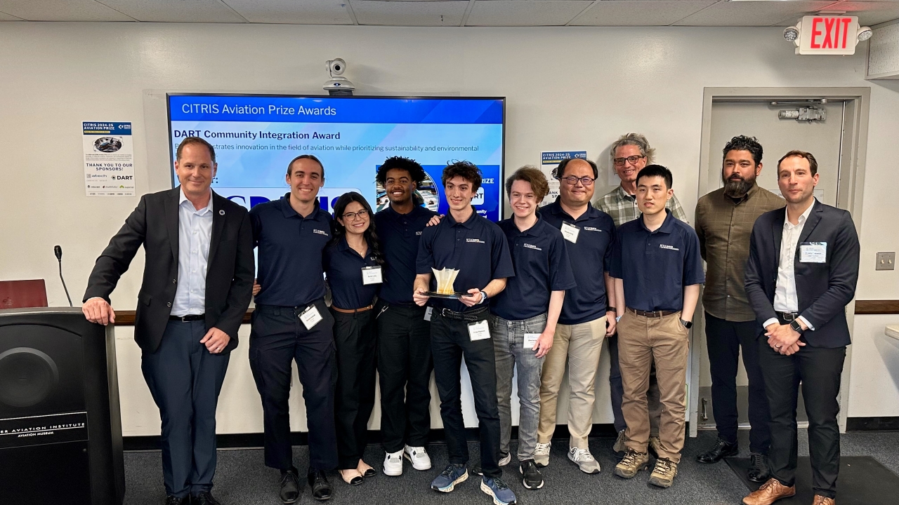 The UC Davis team standing together in front of a screen that says "CITRIS Aviation Prize Winners"