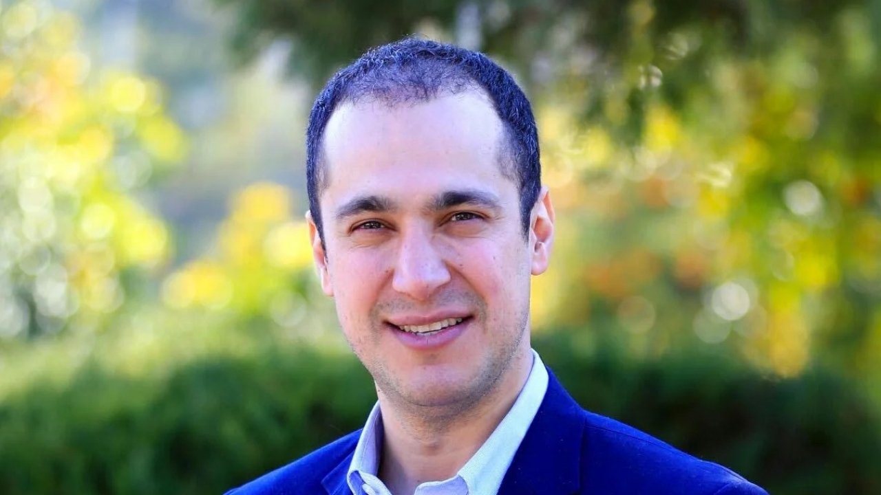 Kaveh Madani in a blue blazer standing outdoors