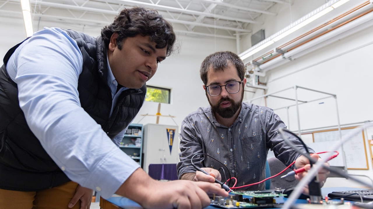 Two people work in lab
