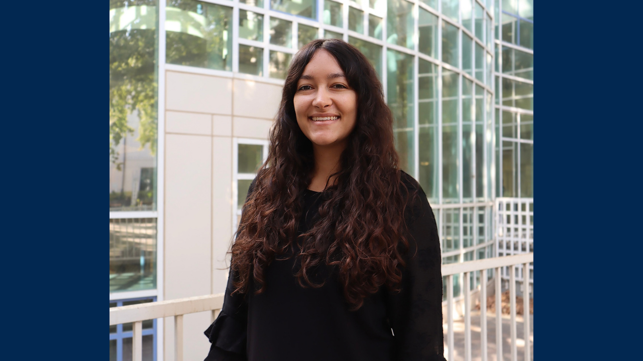 Research librarian Rebeccah Yterdal smiling near large windows