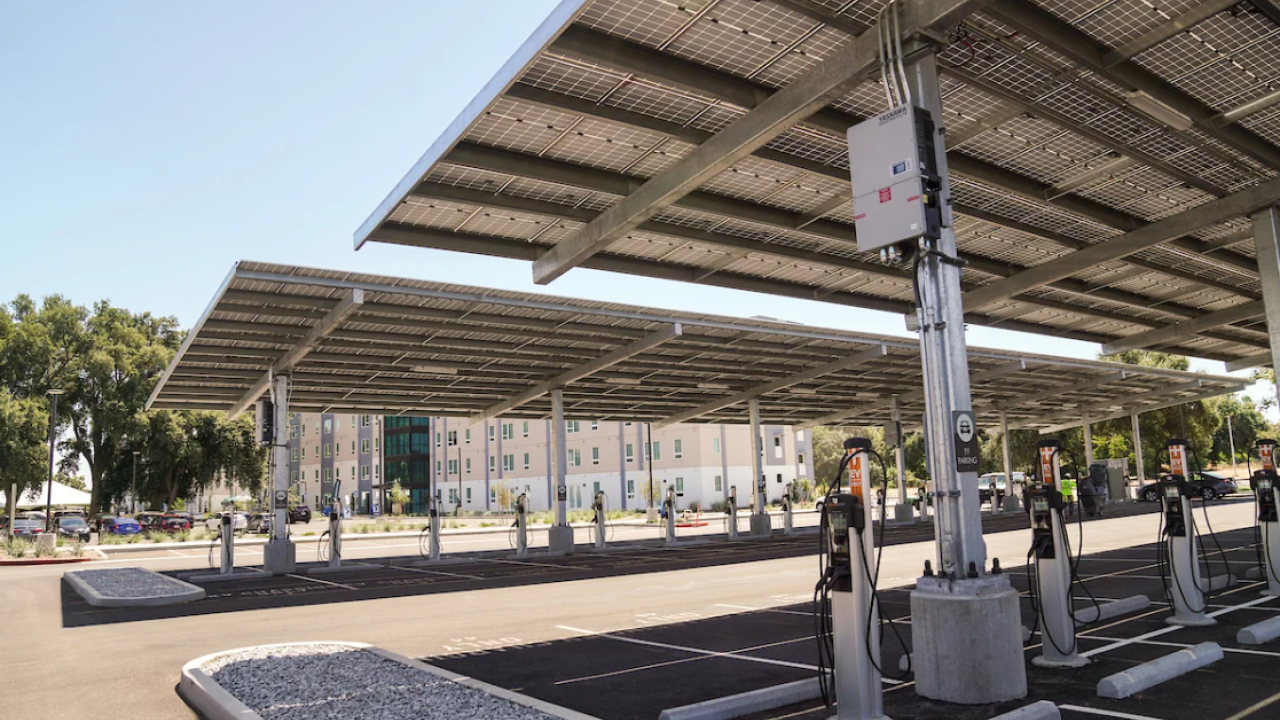 Solar panels in parking lot above electric vehicle charging stations
