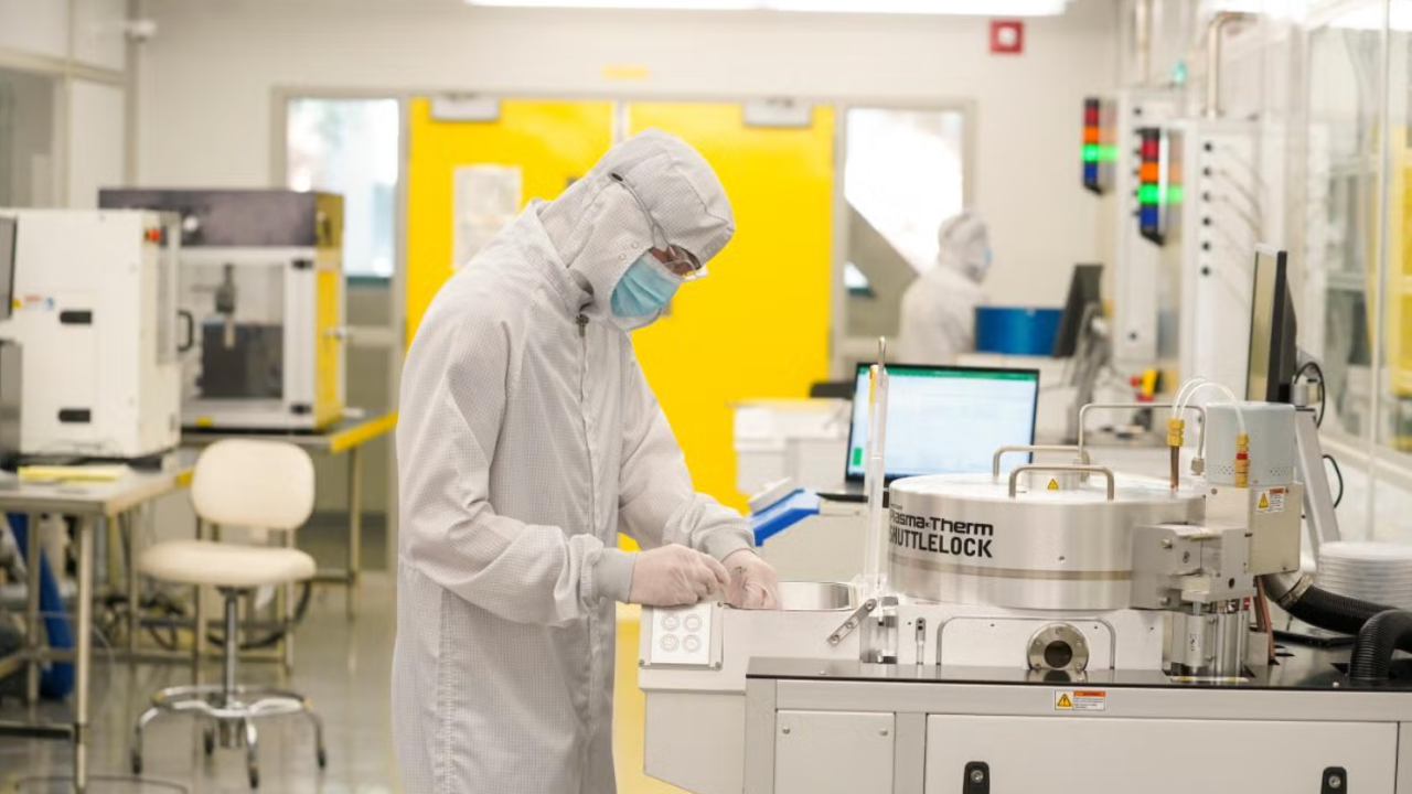 Person in CNM2 wears PPE and operates lab equipment