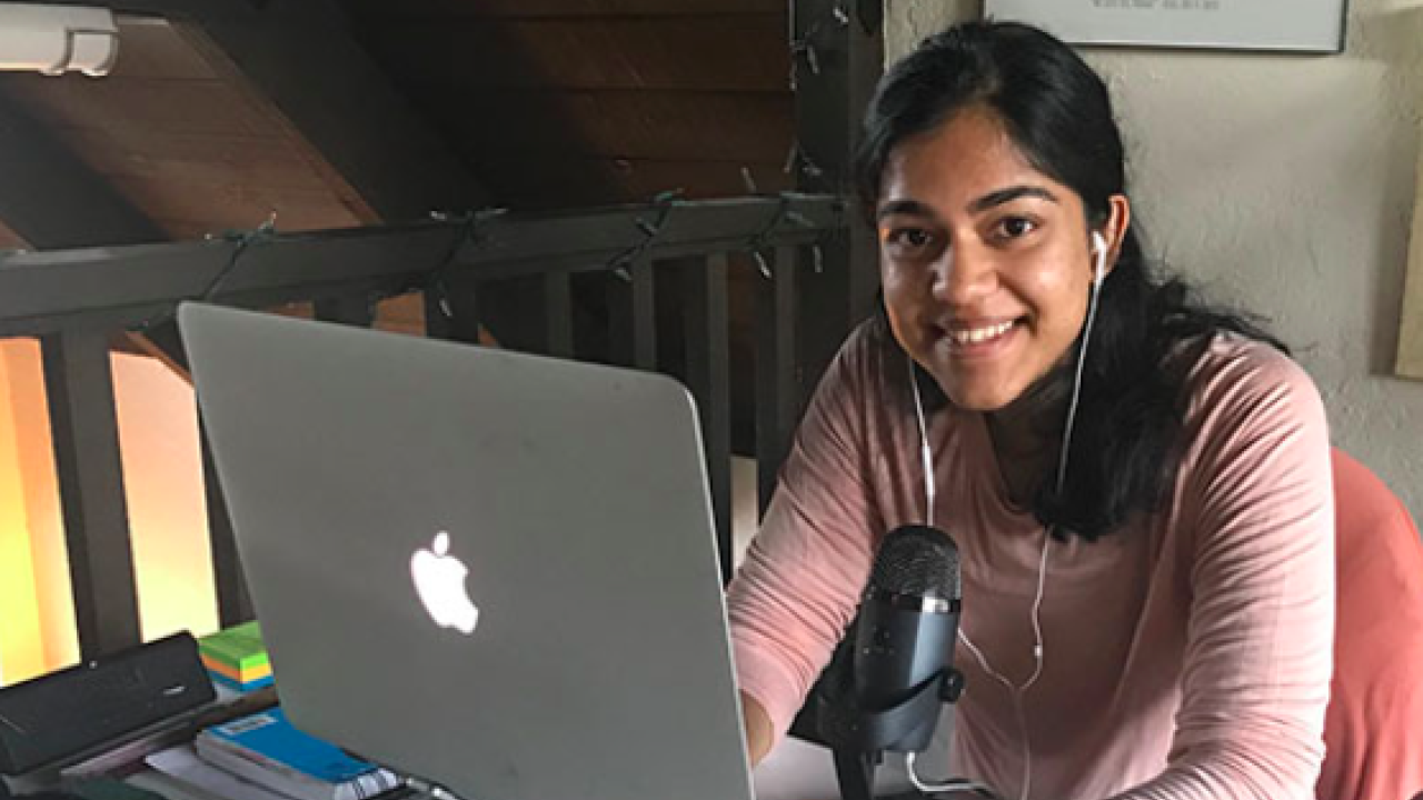Ashna on her laptop with a microphone
