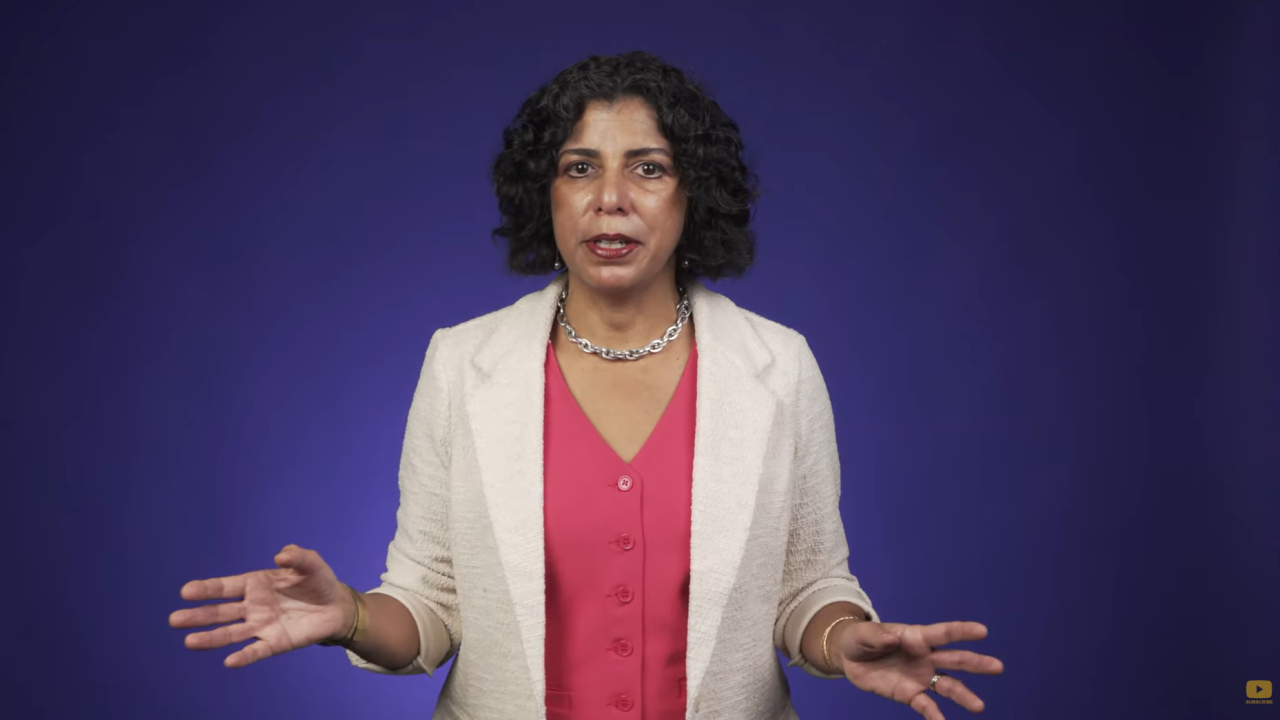 Raissa D’Souza speaking with a purple background