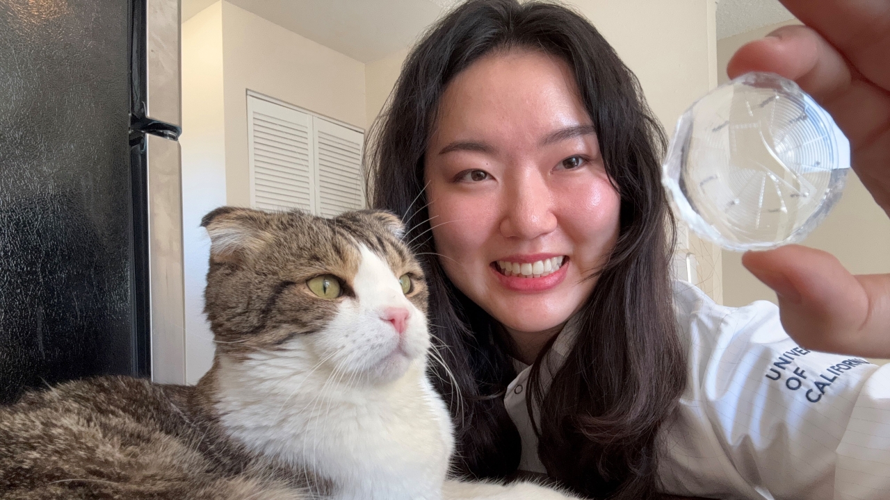A woman poses with her cat