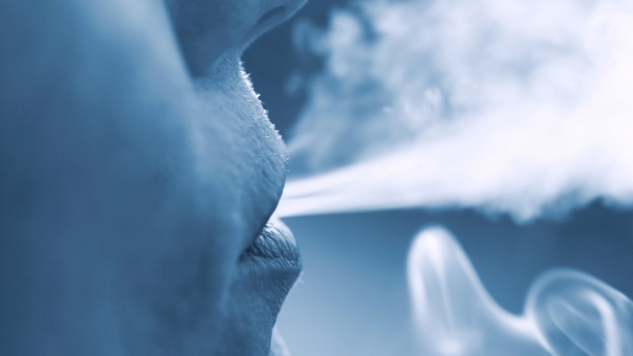 Someone blowing smoke out of their mouth