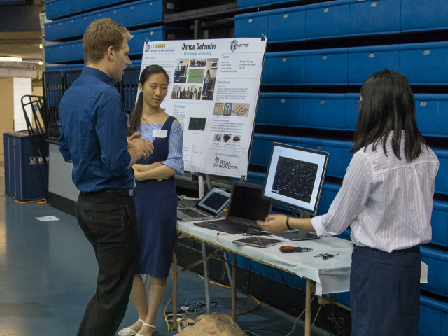 Evaluator demoing a student project at the 2019 Engineering Design Showcase.