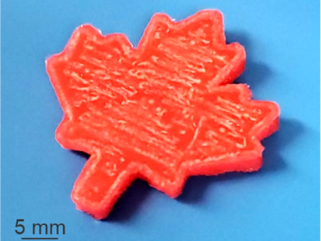 Reddish orange printed maple leaf on a blue background, 5mm large