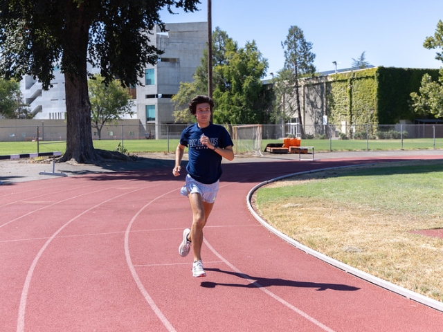 Zachary Graeber runs on a track at UC Davis