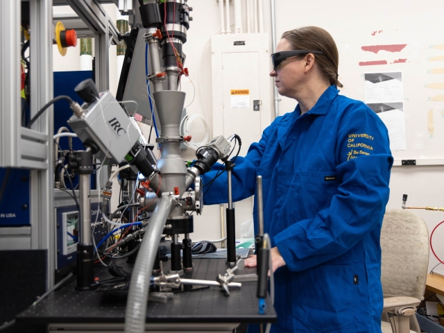 Nicole O'Shea handling lab machinery